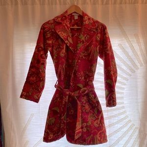 Bright and colorful beautiful trench-style coat with floral pattern.